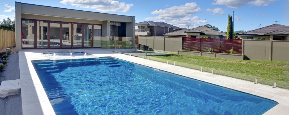 Simple pool landscaping with tiling around the swimming pool